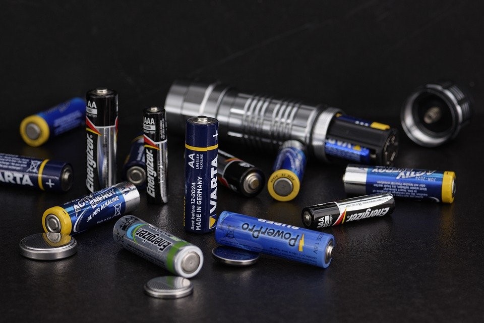 Different batteries placed on a black surface